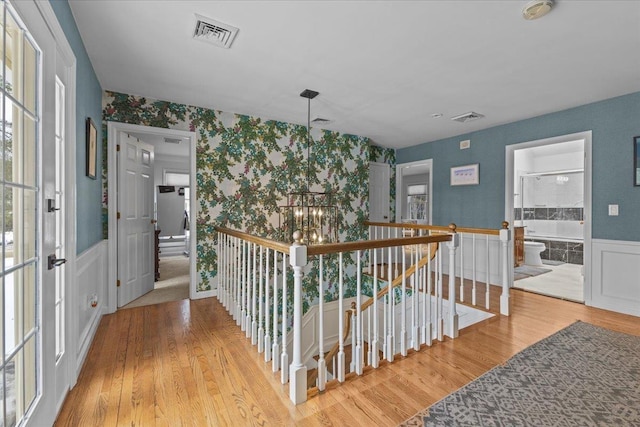 corridor with hardwood / wood-style flooring