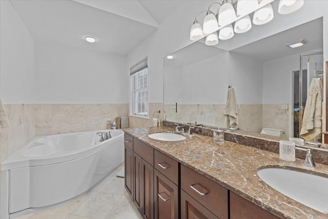 bathroom with tile patterned floors, vanity, toilet, and a bathtub