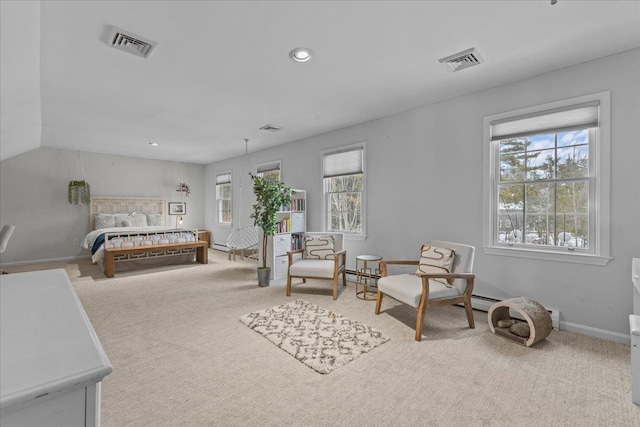 bedroom with a baseboard radiator and light colored carpet