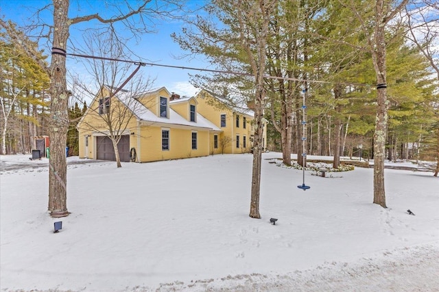 yard layered in snow with a garage