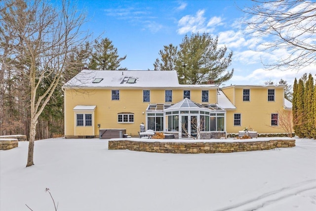 snow covered house with a hot tub and a lanai