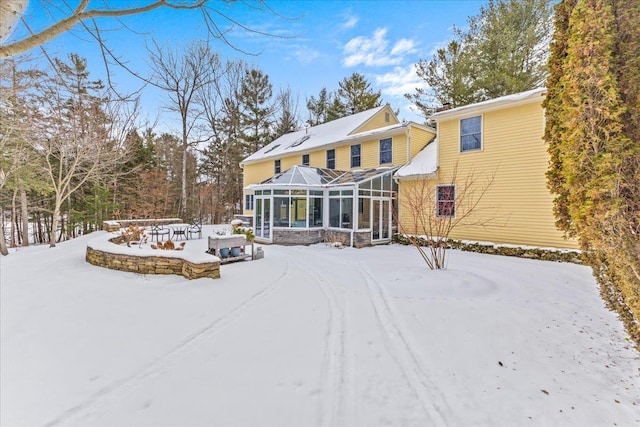 snow covered house with glass enclosure