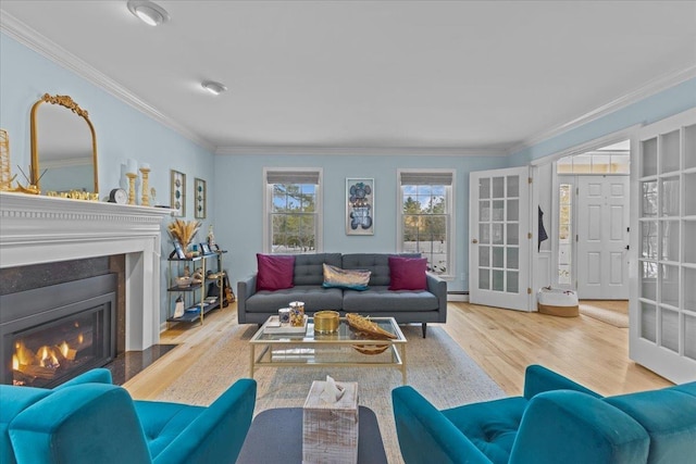 living room featuring crown molding, baseboard heating, french doors, and light wood-type flooring