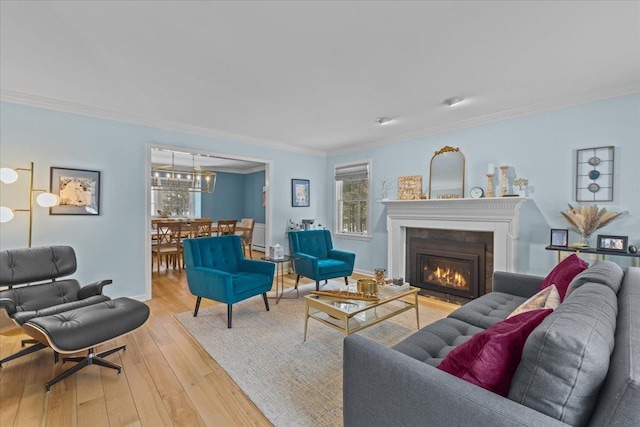 living room with crown molding and light hardwood / wood-style flooring