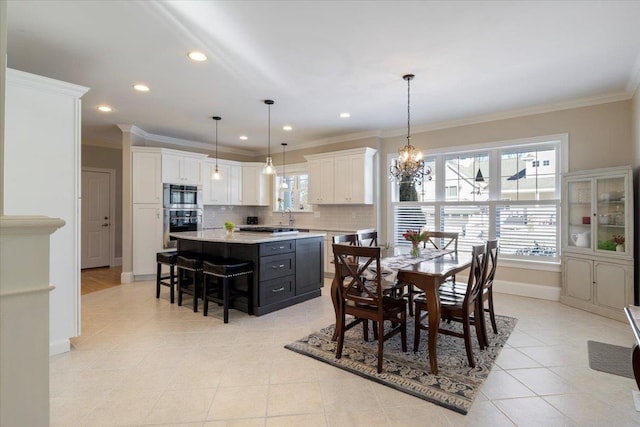 tiled dining space featuring ornamental molding and a chandelier