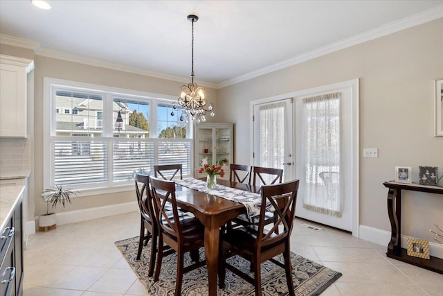 tiled dining space with crown molding and an inviting chandelier