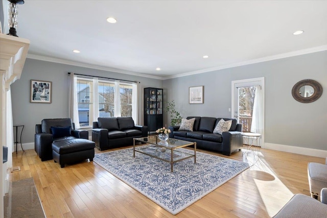 living room featuring ornamental molding and light hardwood / wood-style flooring