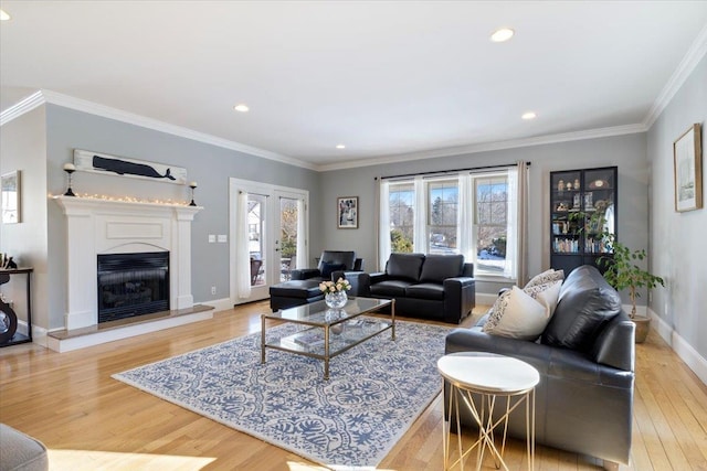 living room featuring ornamental molding and light wood-type flooring