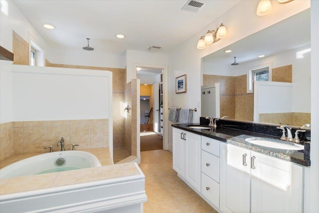 bathroom featuring tile patterned floors, independent shower and bath, and vanity