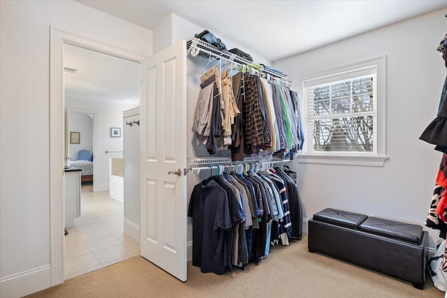 spacious closet featuring light carpet