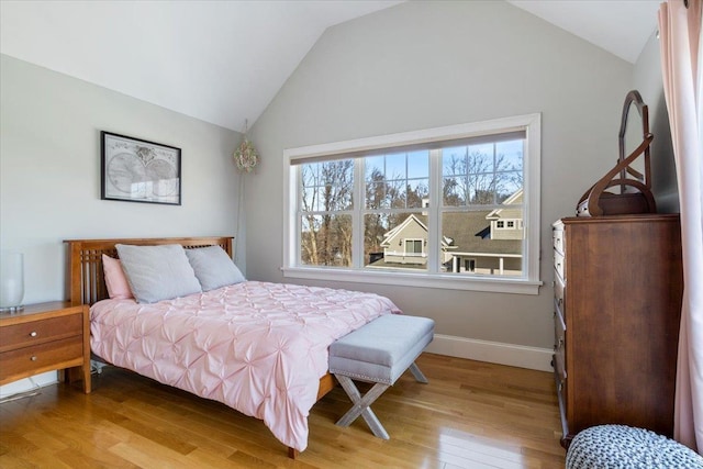 bedroom featuring lofted ceiling and hardwood / wood-style floors