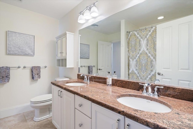 bathroom featuring vanity, toilet, and tile patterned flooring