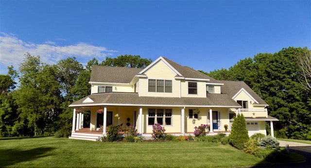 view of front of property with a porch, a garage, and a front yard