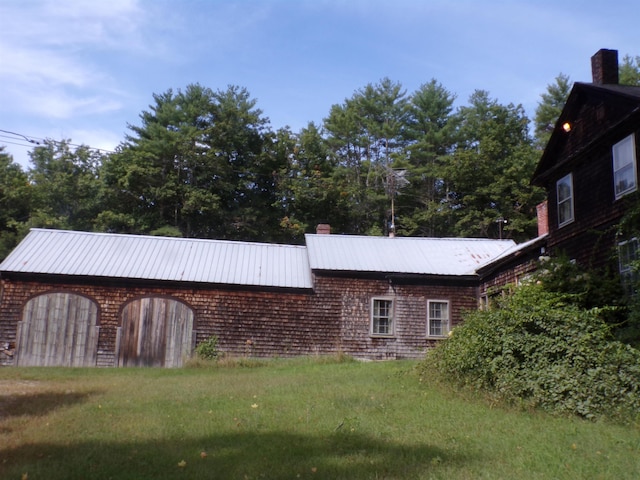 view of side of home featuring a lawn