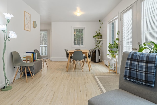 dining room featuring a baseboard radiator and hardwood / wood-style floors