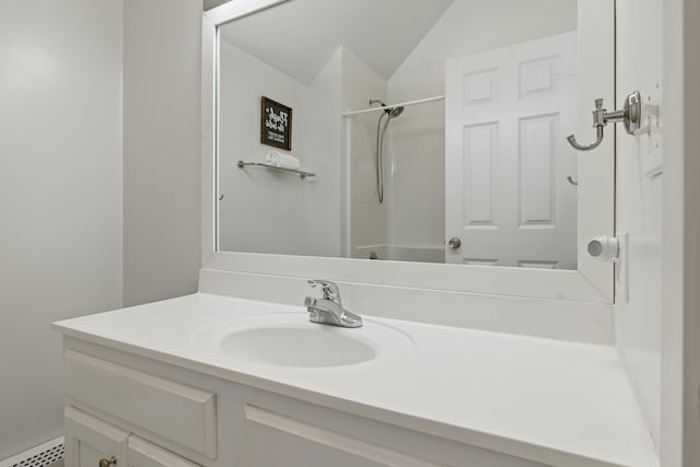 bathroom with walk in shower and vanity