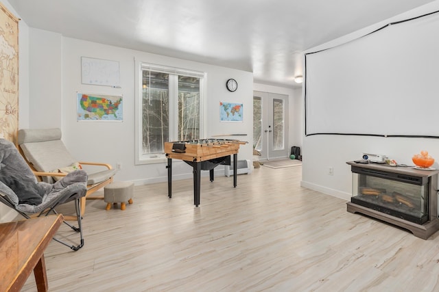 living area featuring french doors and light wood-type flooring