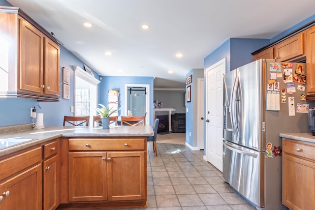 kitchen featuring stainless steel fridge with ice dispenser and light tile patterned flooring