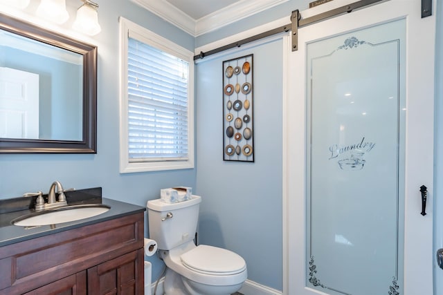 bathroom featuring vanity, ornamental molding, and toilet