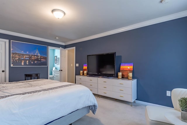 carpeted bedroom featuring ornamental molding and ensuite bathroom