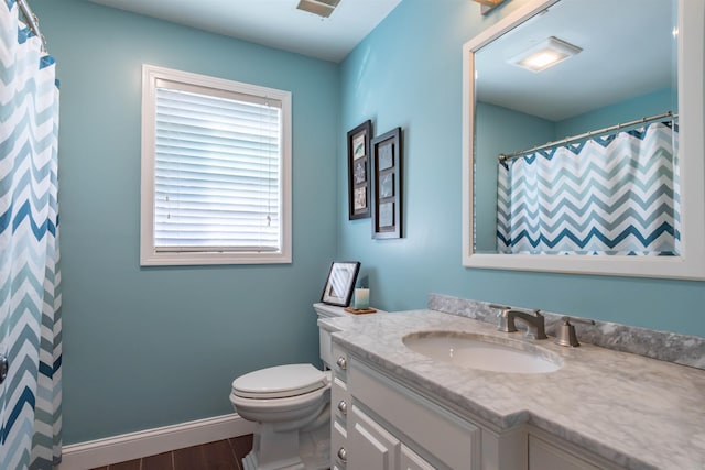 bathroom featuring vanity, toilet, and wood-type flooring