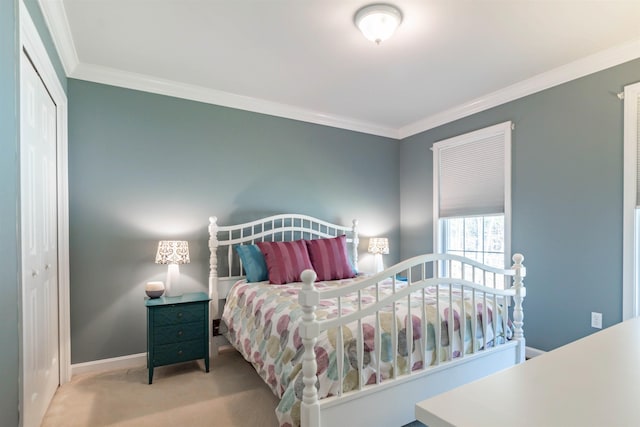 bedroom featuring crown molding, light colored carpet, and a closet