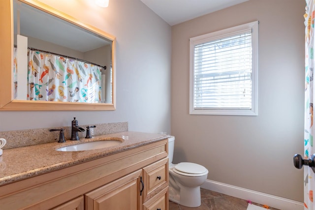 bathroom with vanity, tile patterned floors, and toilet