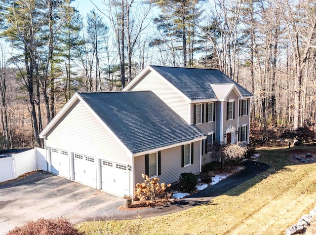 view of home's exterior featuring a garage and a yard