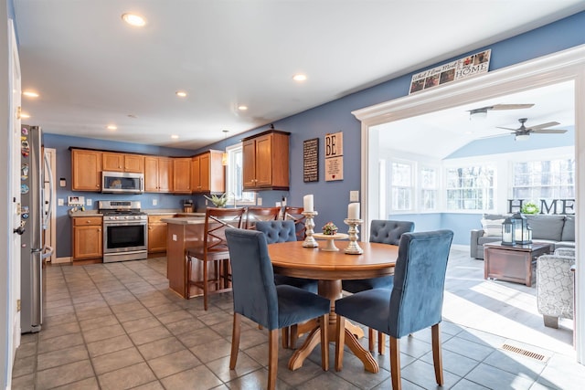 dining area with ceiling fan and light tile patterned floors