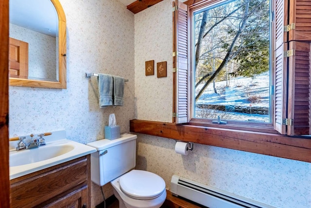 bathroom with vanity, a baseboard heating unit, and toilet