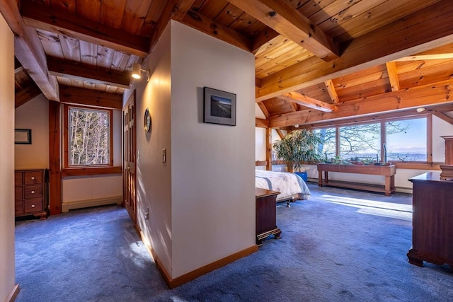 hallway featuring wood ceiling, vaulted ceiling with beams, and dark colored carpet