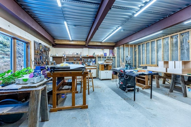 dining space featuring concrete floors and a workshop area