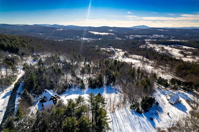 snowy aerial view featuring a mountain view