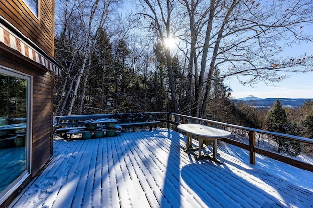 snow covered deck featuring a mountain view