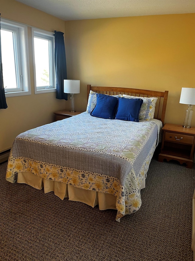 bedroom with a baseboard radiator and a textured ceiling