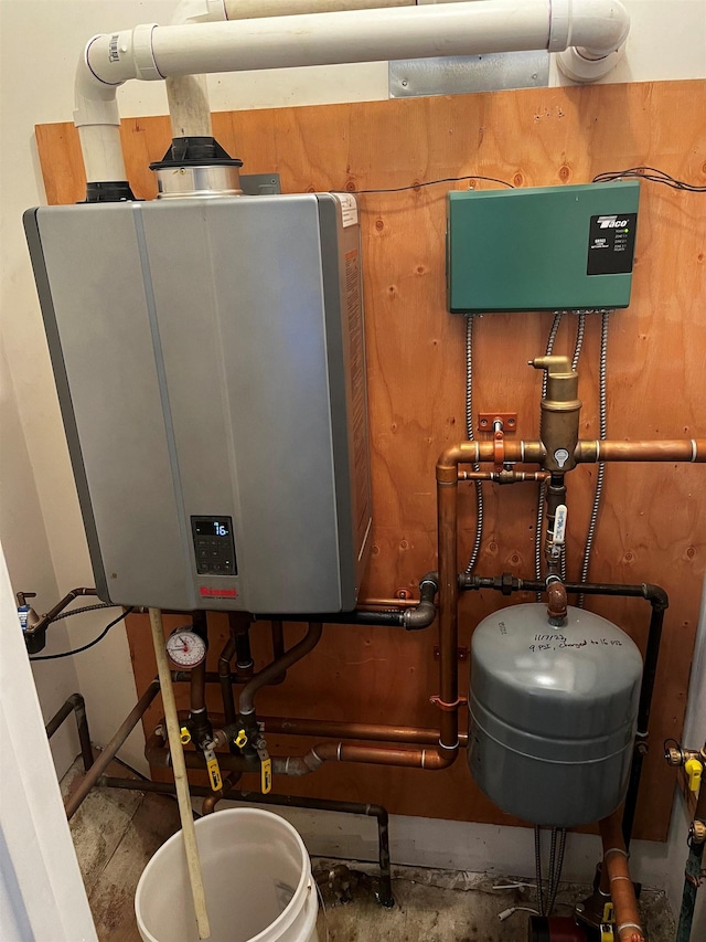 utility room with tankless water heater