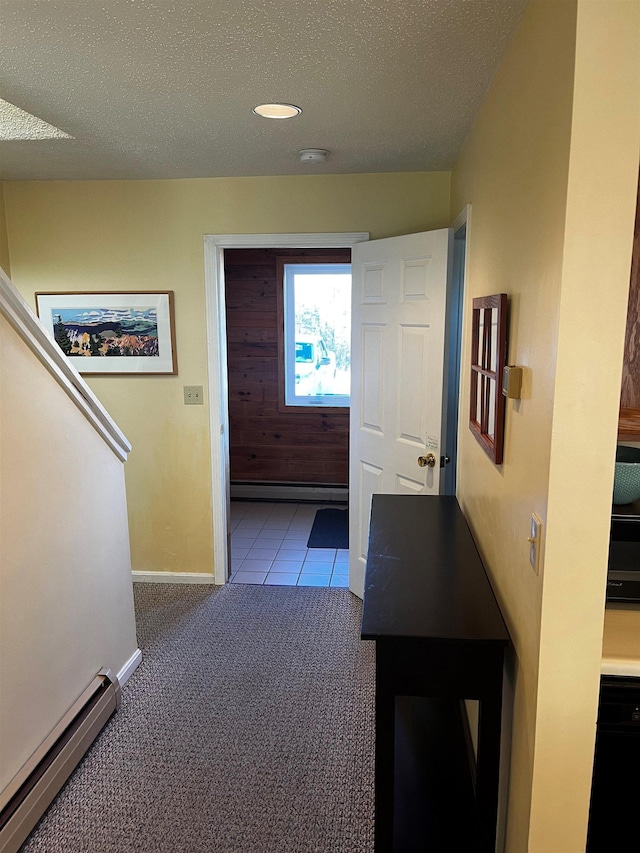 hall featuring a baseboard radiator, light carpet, and a textured ceiling