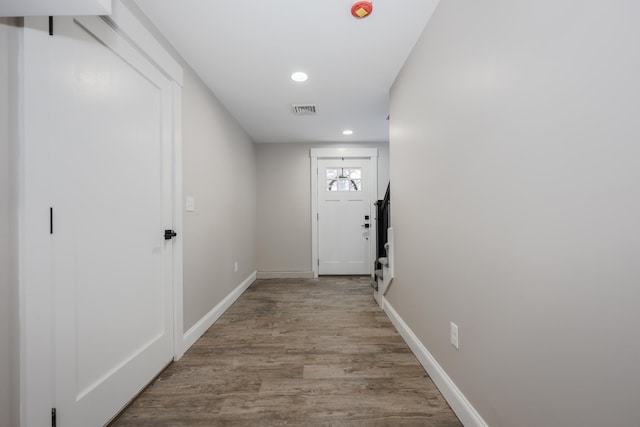 doorway to outside with baseboards, recessed lighting, visible vents, and light wood-style floors