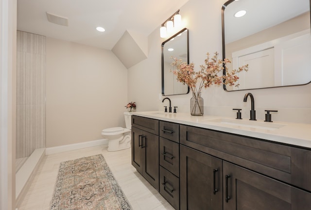 full bathroom featuring a sink, baseboards, toilet, and double vanity