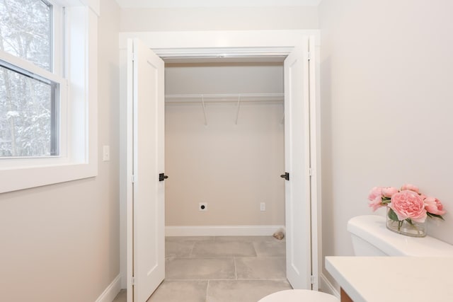 bathroom featuring vanity, baseboards, and toilet