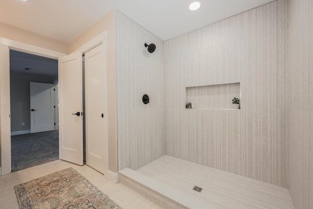 bathroom with tiled shower