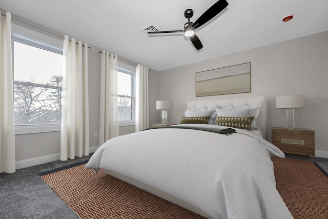 bedroom featuring baseboards, dark carpet, and a ceiling fan