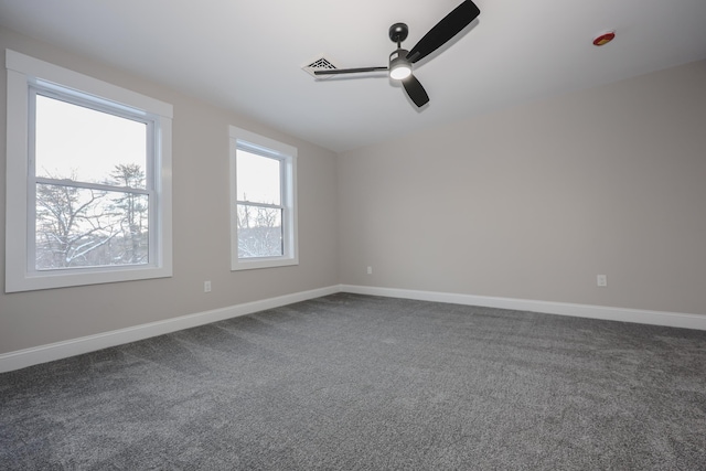 spare room featuring ceiling fan, carpet flooring, and baseboards