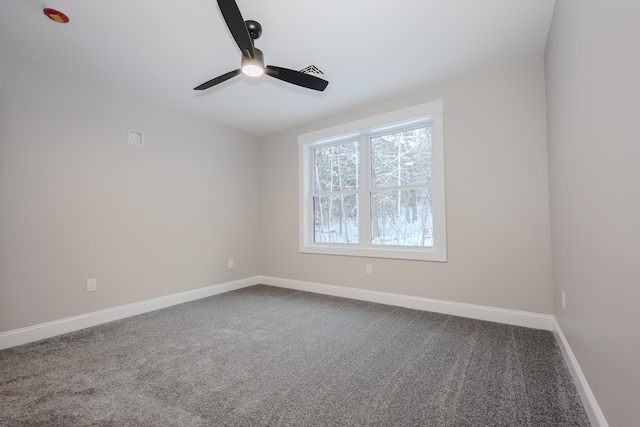 empty room with carpet flooring, baseboards, and a ceiling fan