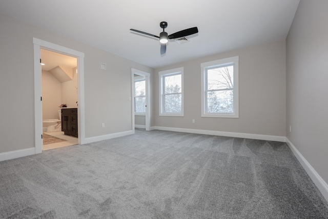 unfurnished bedroom featuring ceiling fan, connected bathroom, and light colored carpet