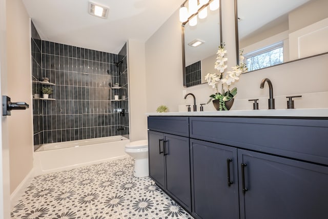 full bathroom with tile patterned flooring, vanity, toilet, and tiled shower / bath