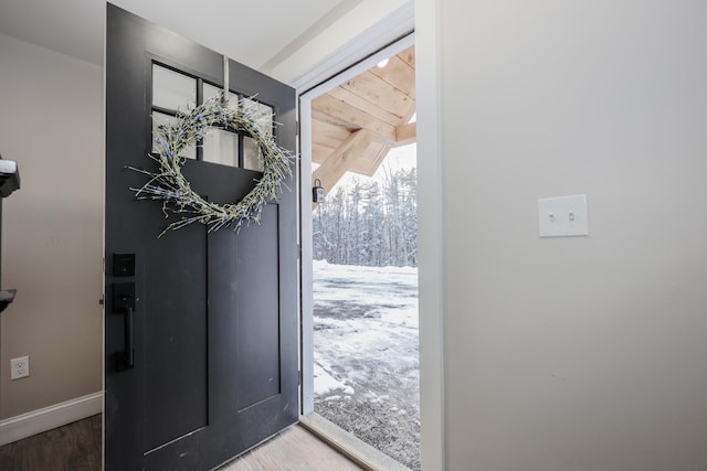 entrance foyer featuring baseboards and wood finished floors