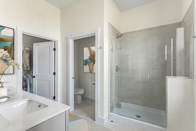 bathroom featuring vanity, an enclosed shower, tile patterned floors, and toilet