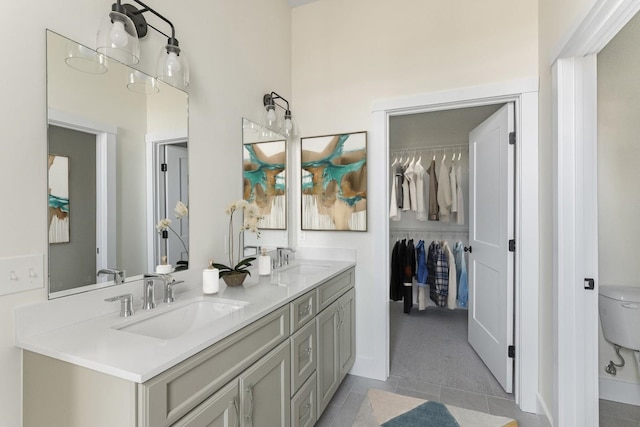 bathroom with vanity, toilet, and tile patterned flooring