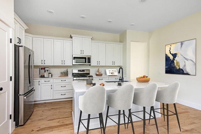 kitchen featuring white cabinetry, sink, and appliances with stainless steel finishes